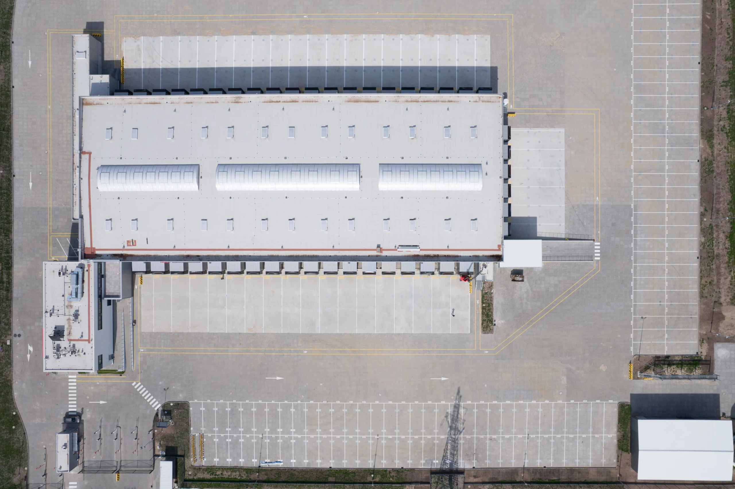 Aerial Top View of a Modern Warehouse and Parking Lot that has been cleaned using a commercial sweeper company